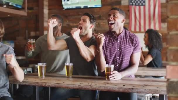 Group Male Friends Sitting Sports Bar Drinking Beer Watching Game — Stock Video