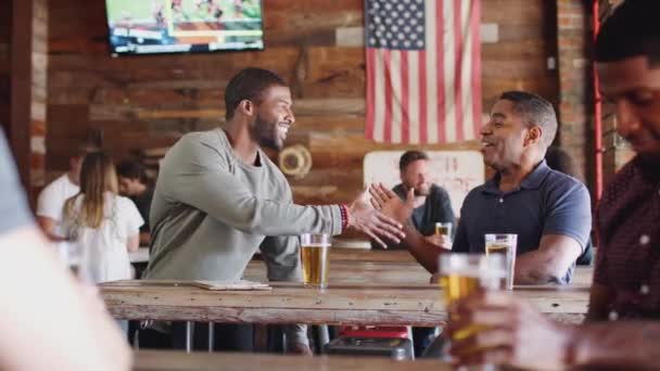 Two Male Friends Shake Hands Meet Sports Bar Beer Shot — Stock Video