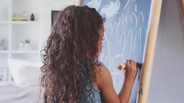 Young Hispanic Girl Drawing Chalks Blackboard Home Close Back View — Stock Video