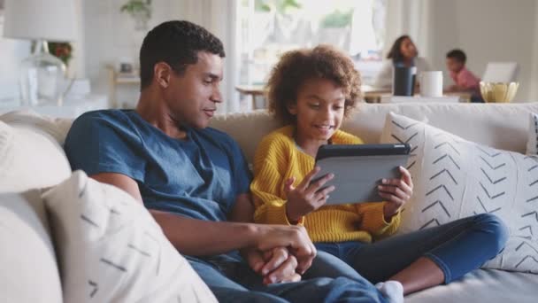 Father His Pre Teen Daughter Sofa Using Tablet Computer Mum — Stock Video