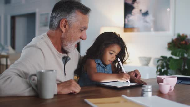 Senior Man Talking Granddaughter While She Uses Stylus Tablet Computer — Stock Video