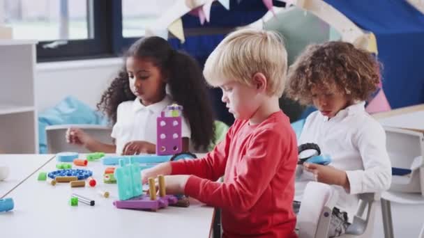 White Infant School Boy Using Educational Construction Toys His Classmates — Stock Video