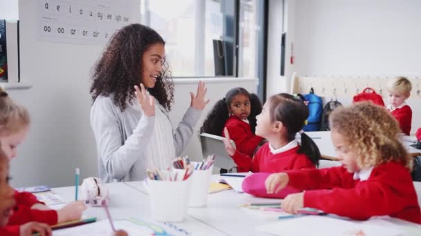 Jonge Vrouwelijke Kleuterschool Leraar Zittend Aan Een Tafel Een Klas — Stockvideo