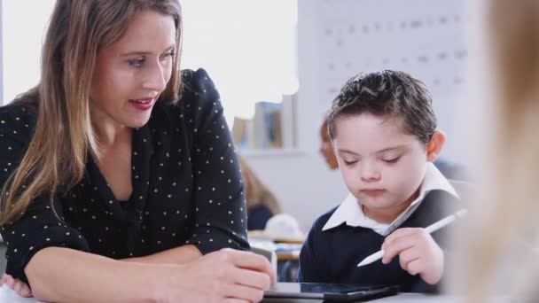Female Teacher Working Syndrome Boy Using Tablet Primary School Front — Stock Video