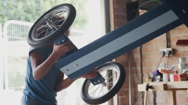 Side View Pre Teen Boy Standing Workbench Garage Turning His — Stock Video