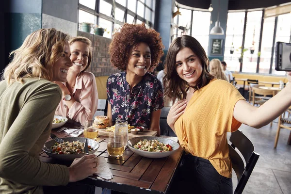 四个年轻的女性朋友会议饮料和食物在餐厅自拍 — 图库照片