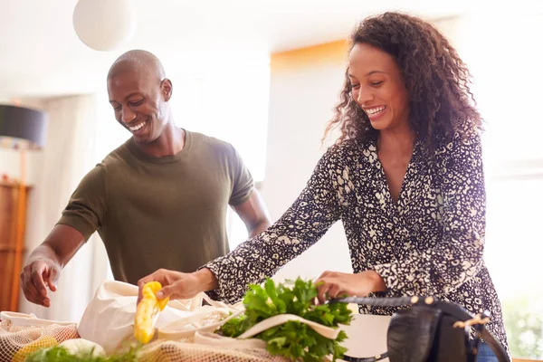 Couple Returning Home Shopping Trip Unpacking Plastic Free Grocery Bags — Stock Photo, Image