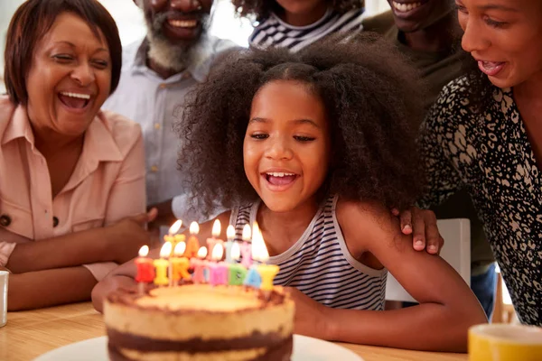 ケーキとキャンドルで自宅で孫娘の誕生日を祝う多世代の家族 — ストック写真