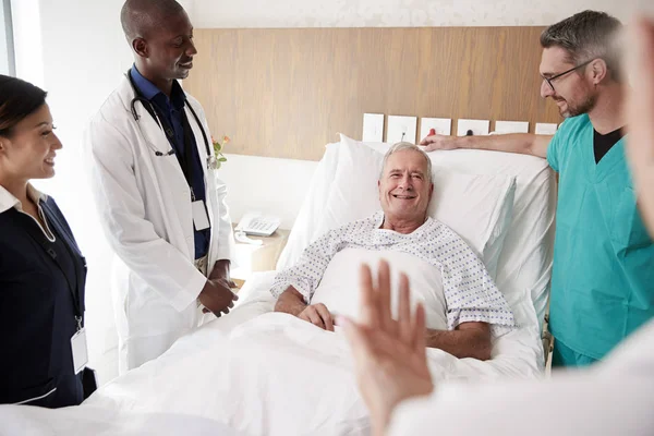 Kıdemli Erkek Hastanın Yatağında Yuvarlak Toplantı Sağlık Ekibi — Stok fotoğraf