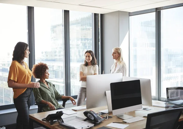 Four Female Colleagues Discussion Desk Creative Office Looking Each Other — Stock Photo, Image