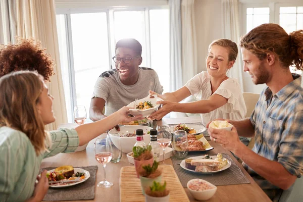 Two Young Adult Women Passing Dish Dinner Table Lunch Friends — Stock Photo, Image