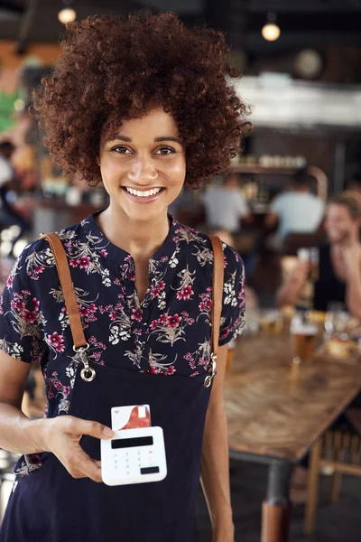 Portrett Waitress Holding Credit Card Betalingsterminal Busy Bar Restaurant – stockfoto