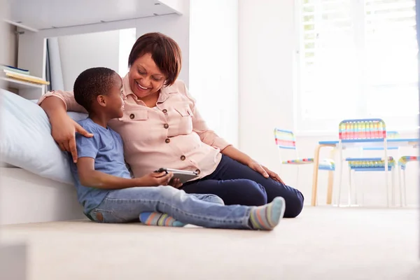 Großmutter Sitzt Mit Enkel Kinderzimmer Und Nutzt Gemeinsam Digitales Tablet — Stockfoto