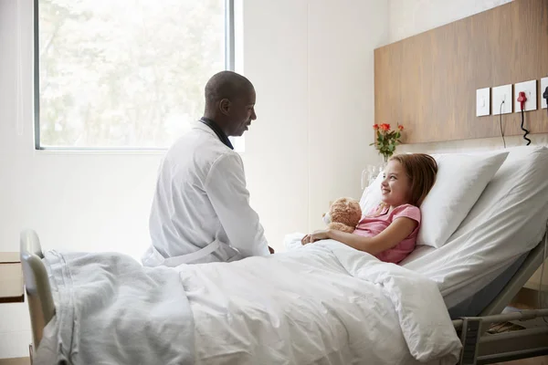 Arzt Besucht Mädchen Das Krankenhausbett Liegt Und Teddybär Umarmt — Stockfoto