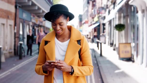 Millennial Black Woman Wearing Yellow Pea Coat Homburg Hat Using — Stock Video