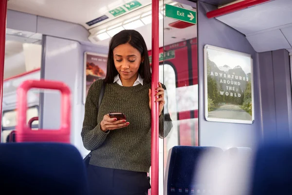 Female Passenger Standing Doors Train Looking Mobile Phone — Stock Photo, Image