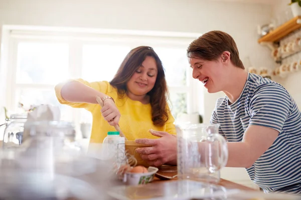 Young Downs Syndrome Couple Baking Kitchen Home — Stock Photo, Image
