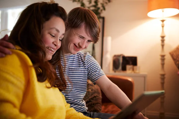 Giovani Sindrome Coppia Seduta Sul Divano Utilizzando Tavoletta Digitale Casa — Foto Stock