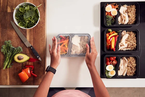キッチンで自宅で健康的な食事のバッチを準備する女性のオーバーヘッドショット — ストック写真