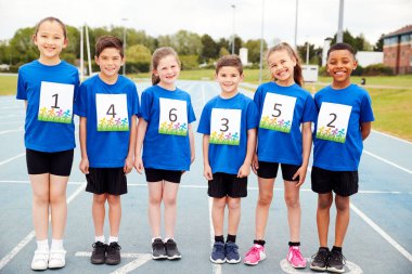 Portrait Of Children On Athletics Track Wearing Competitor Numbers On Sports Day clipart