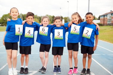 Portrait Of Children On Athletics Track Wearing Competitor Numbers On Sports Day clipart