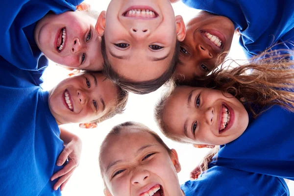 Low Angle View Looking Faces Children Huddle Sports Day — стоковое фото