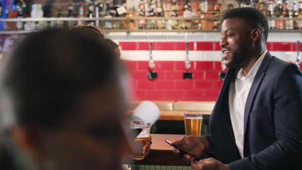 Two Businessmen Checking Mobile Phones Whilst Meeting Drink Bar Shot — Stock Video