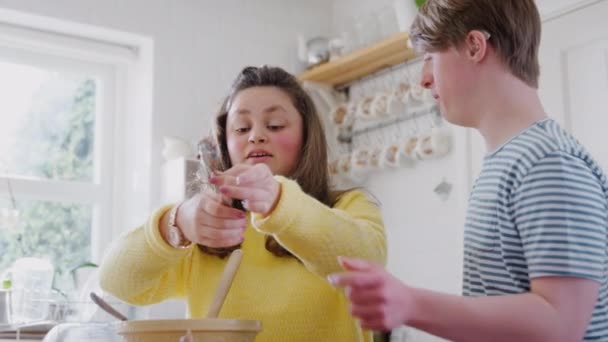 Young Downs Syndrome Couple Baking Kitchen Home Decorating Cupcakes Icing — Stock Video