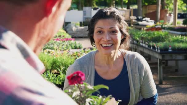Leende Mogen Kvinna Köper Växter Från Manliga Försäljningsassistent Utomhus Trädgårdscenter — Stockvideo