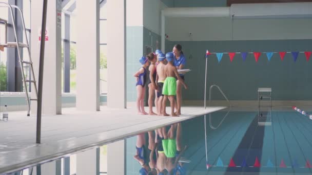 Groupe Enfants Debout Près Piscine Reçoit Briefing Par Entraîneur Féminin — Video