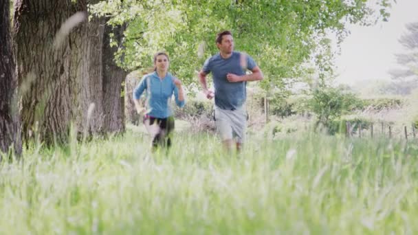 Camera Tracks Upwards Couple Run Countryside Camera Shot Slow Motion — Stock Video