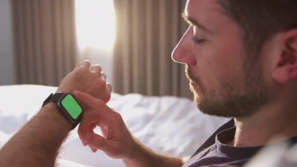 Man Liggande Sängen Tittar Skärmen Smart Klocka Skjuten Slow Motion — Stockvideo