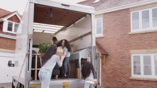 Family Standing Back Removal Truck Unloading Boxes New Home Moving — Stock Video