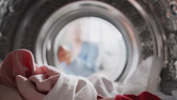 View Washing Machine Woman Opens Door Takes Out Red Sock — Stock Video