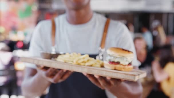Aproape Chelner Ţinând Tava Burger Cartofi Prăjiţi Într Restaurant Aglomerat — Videoclip de stoc