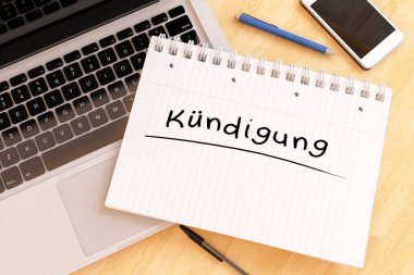 Kuendigung - sonlandırma veya iptalin Almancası - masadaki bir defterde el yazısıyla yazılmış metin - 3D resimleme.