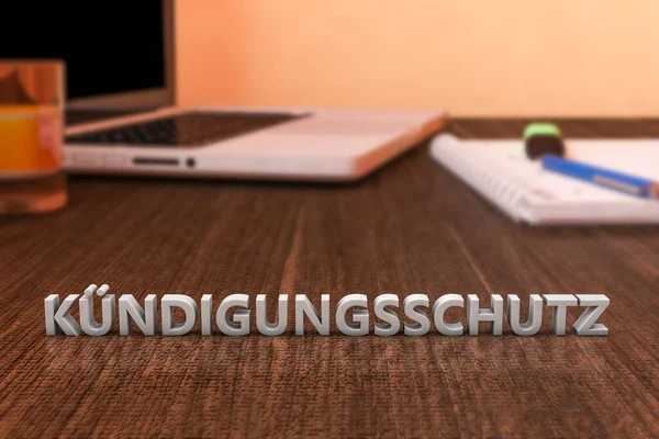 Kuendigungsschutz 解雇から保護するためのドイツ語の単語 ノートパソコンとノートブックと木製の机の上に文字 3Dレンダリング図 — ストック写真