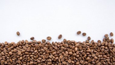 Coffee Beans on Grey Background Natural Light Selective Focus clipart