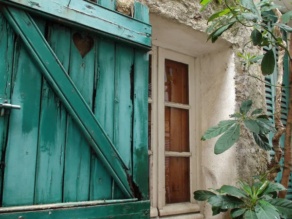 Wooden Window with Open Wooden Shutters in Ramatuelle Old Town in Provence in France Background and Texture Outdoor Concept