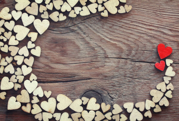 valentine day festive background, pile of plywood heart on wooden table, vintage style, space for text