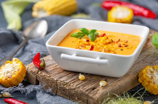 Delicious creamy corn soup with chili in a bowl.