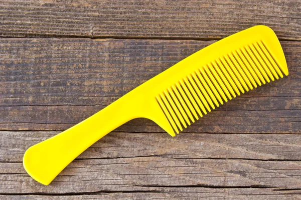 Plastic Yellow Comb Wooden Background — Stock Photo, Image