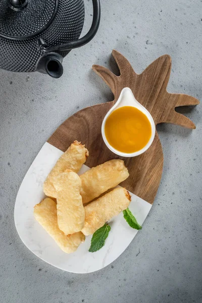 Fried sweet sticks with jam on the board. Close-up shot