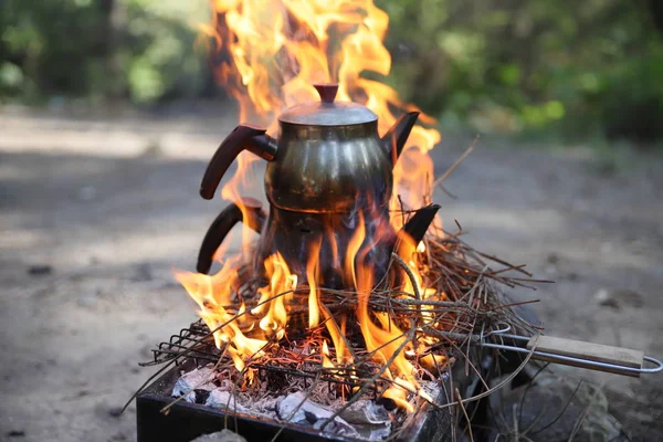 Kettle With Water Heated On The Fire