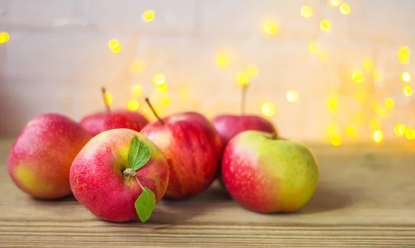 Festive autumn decor of apples on a white brick background with bokeh. The concept of Thanksgiving or Halloween. Space for text — Stock Photo, Image