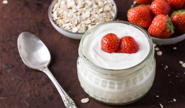 Cam kase kaşık ve starwberries rustik arka plan üzerinde beyaz yoğurt.