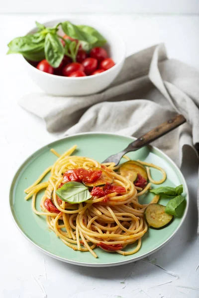 healthy dinner, vegan pasta with tomatoes and zucchi