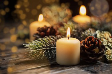 Koyu arka plan ve bokeh etkisi üzerinde mum ile Noel dekorasyon
