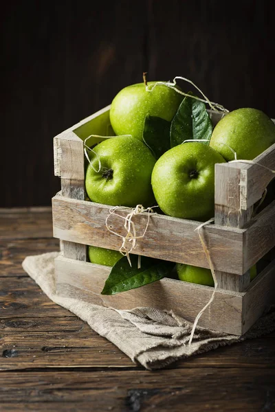 Green apples in rustic box, selective focus
