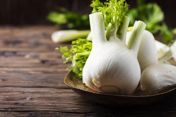 Raw fresh fennel on rustic wooden table, selective focus